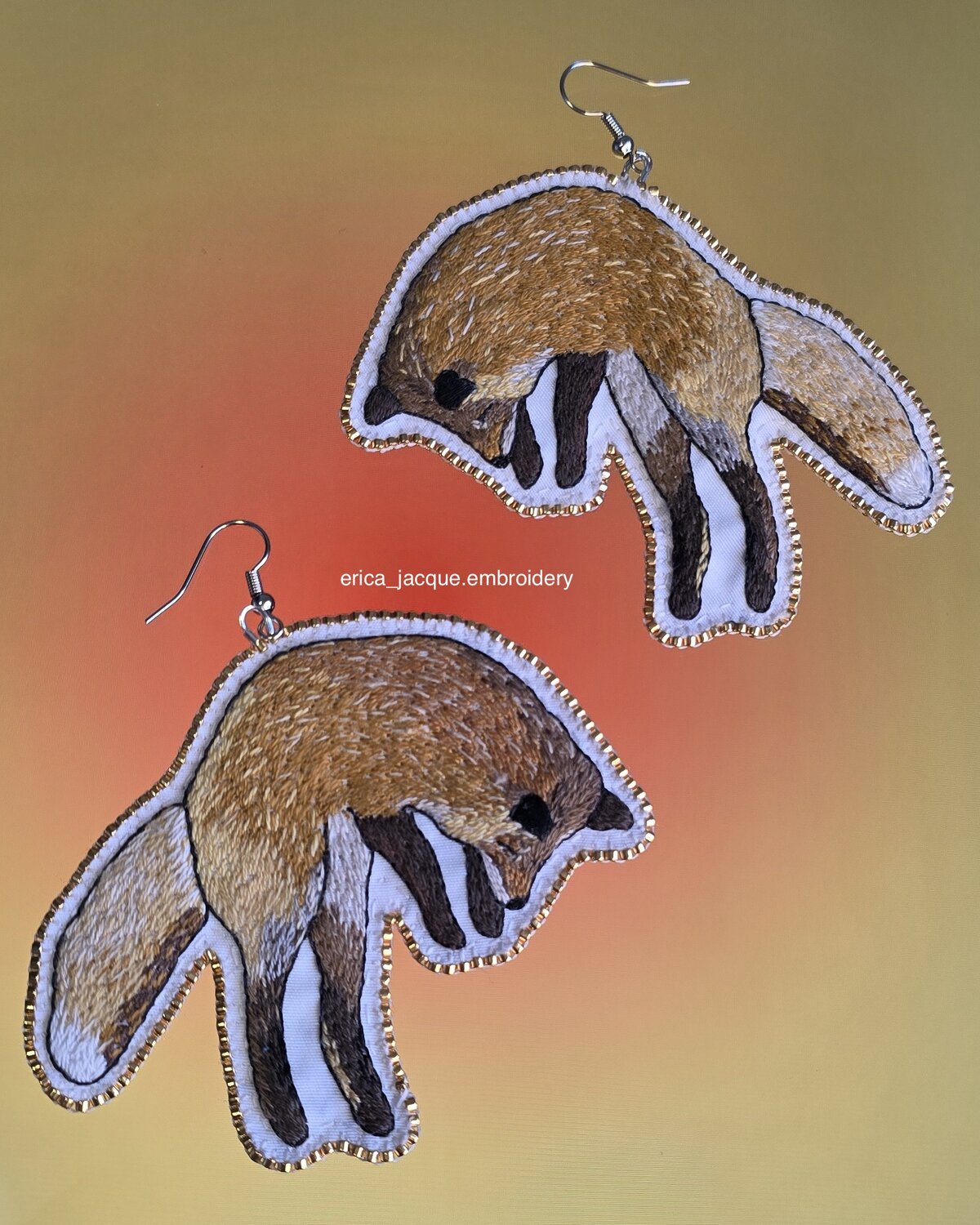 Pair of hand-embroidered jumping fox earrings edged with gold seed beads